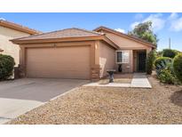 Single-story house with a two-car garage and desert landscaping at 1107 E Lakeview Dr, San Tan Valley, AZ 85143