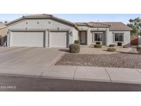 Charming single-story home featuring a two car garage and low maintenance desert landscaping at 1242 E Bartlett Way, Chandler, AZ 85249