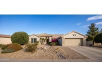 Single-story home with two-car garage and desert landscaping at 15506 W Skyview Way, Surprise, AZ 85374