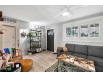 Cozy living room featuring a gray sectional sofa and stylish shelving at 2087 E 10Th St, Tempe, AZ 85281