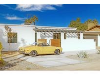 Stunning mid-century modern home with a remodeled exterior and landscaped yard at 3810 E Shea Blvd, Phoenix, AZ 85028