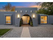 Inviting entryway with arched doorway, stylish lighting, and landscaping at 5429 E Bloomfield Rd, Scottsdale, AZ 85254