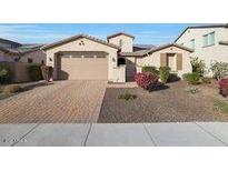 Beautiful two-story home with a three-car garage and well-manicured landscaping at 5450 W Taro Ln, Glendale, AZ 85308