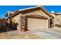 House exterior featuring stone accents and a two-car garage at 660 N Maple St, Chandler, AZ 85226