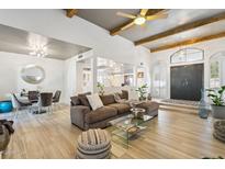 Spacious living area with hardwood floors, exposed beams, and a neutral color scheme at 8008 E Del Rubi Dr, Scottsdale, AZ 85258