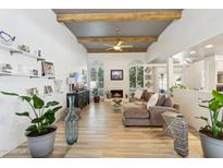 Living room with hardwood floors, a fireplace, and abundant natural light at 8008 E Del Rubi Dr, Scottsdale, AZ 85258