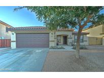 Single-story home with brown garage door and landscaped front yard at 9136 E Plata Ave, Mesa, AZ 85212