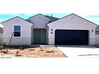 Charming single-story home with a large garage and desert landscaping in the front yard at 1531 E Lardner Dr, Casa Grande, AZ 85122