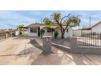 Charming single story home with a landscaped front yard and driveway at 1915 E Hidalgo Ave, Phoenix, AZ 85040