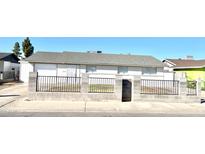 House exterior featuring a two-car garage and a well-maintained front yard at 2802 N 50Th Ln, Phoenix, AZ 85035