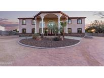 Two-story house with stucco exterior, large windows, and a porte-cochere at 8315 E Palm Ln, Mesa, AZ 85207
