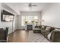 Living room featuring L-shaped sofa, fireplace, and hardwood floors at 16 W Encanto Blvd # 409, Phoenix, AZ 85003