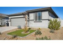 Single-story home with gray exterior, two-car garage, and landscaped front yard at 17852 W Country Club Ter, Surprise, AZ 85387