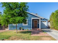 Charming blue house with brick pathway, landscaped lawn, and attached garage at 2614 N 15Th St, Phoenix, AZ 85006