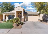 Single-story home with landscaped lawn, two-car garage, and neutral color palette at 2910 E Quiet Hollow Ln, Phoenix, AZ 85024