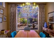 Bright dining room with large window, chandelier, and wooden table at 3055 N Red Mountain Rd # 149, Mesa, AZ 85207