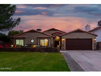 Beautiful stucco home with a 2 car garage, mature landscaping, and a welcoming front porch at 5402 E Paradise Ln, Scottsdale, AZ 85254