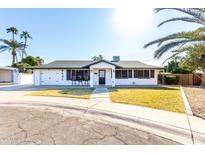 Updated single story home with a landscaped front yard and charming curb appeal at 8431 E Stella Ln, Scottsdale, AZ 85250