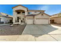 Two-story house with a two-car garage and desert landscaping at 12425 W Pima St, Avondale, AZ 85323