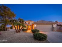 Single-story home with desert landscaping, tan stucco, and a two-car garage at 15583 W Big Sky Dr, Surprise, AZ 85374