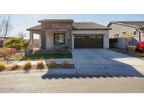 Single-story home with stone accents and a two-car garage at 20487 W Minnezona Ave, Buckeye, AZ 85396