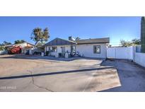 Updated single story home with new paint, front porch, and gated driveway at 11451 E Broadway Rd, Mesa, AZ 85208