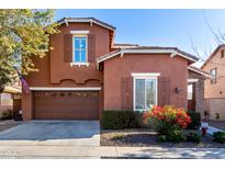 Two-story house with brown exterior, two-car garage, and landscaped front yard at 13627 N 150Th Ave, Surprise, AZ 85379