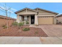 Single-story home with two-car garage and landscaped front yard at 19929 W Roma Ave, Litchfield Park, AZ 85340