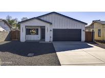 Newly built home with modern facade, driveway, and landscaped yard at 205 E Jackson Ave, Buckeye, AZ 85326