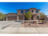 Two-story house with three-car garage and landscaped front yard at 28225 N 65Th Ln, Phoenix, AZ 85083