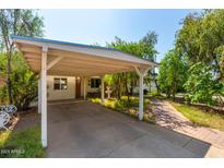 Brick walkway leads to charming ranch home with carport and established landscaping at 2825 N 33Rd Pl, Phoenix, AZ 85008