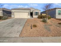 Single-story house with a two-car garage and desert landscaping at 30734 W Clarendon Ave, Buckeye, AZ 85396