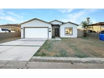 Newly constructed single-story home with a two-car garage and front yard at 6638 S 6Th Ave, Phoenix, AZ 85041