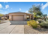 Single-story home with a two-car garage and desert landscaping at 7105 E Hibiscus Way, Scottsdale, AZ 85266