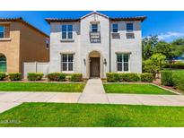 Two-story home with front yard landscaping and walkway at 875 S Brewer Dr, Gilbert, AZ 85296