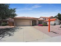 Single-story home with a two-car garage and landscaped front yard at 9176 N 82Nd Ln, Peoria, AZ 85345