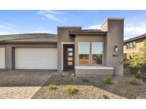 Modern home exterior with two-car garage and landscaped front yard at 18231 E Coronado Cave Ct, Rio Verde, AZ 85263