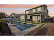 Stunning backyard oasis featuring a sparkling pool and spacious patio at 3045 E Bloomfield Pkwy, Gilbert, AZ 85296