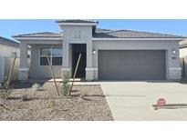 New single-story home with a two-car garage and desert landscaping at 4932 S 105Th Dr, Tolleson, AZ 85353