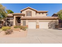 Two-story house with a three-car garage and desert landscaping at 6216 W Morrow Dr, Glendale, AZ 85308