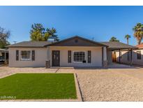 Newly renovated single story home with artificial turf lawn and updated landscaping at 1018 S Butte Ave, Tempe, AZ 85281