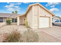 Charming home features desert landscaping, a two-car garage, and a welcoming entrance at 1638 E Sandra Ter, Phoenix, AZ 85022