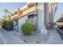 Exterior view of condo building, showing landscaping and parking at 1645 W Baseline Rd # 2075, Mesa, AZ 85202