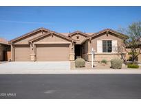 Charming single-story home with a three-car garage and desert landscaping at 18404 W Long Lake Rd, Goodyear, AZ 85338