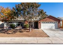 Brick home with landscaped yard and two-car garage at 2193 S Tucana Ln, Gilbert, AZ 85295