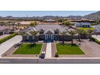 Luxury home with a large front yard, three-car garage, and a stunning view of the surrounding area at 21987 E Stacey Rd, Queen Creek, AZ 85142