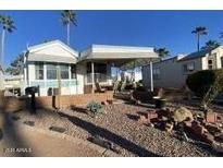 Mobile home exterior with covered porch and landscaped yard at 2271 S Seminole Dr, Apache Junction, AZ 85119