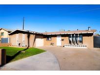 Tan single story home with a 1-car garage and well-manicured lawn at 4320 W Keim Dr, Glendale, AZ 85301