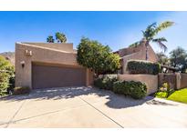 Spanish style home with a large garage and mature landscaping at 4446 E Camelback Rd # 109, Phoenix, AZ 85018