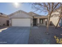 Single-story house with a two-car garage and desert landscaping at 44865 W Horse Mesa Rd, Maricopa, AZ 85139